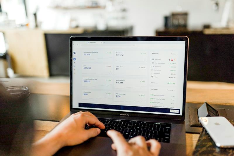 Person working on a laptop showing a business dashboard